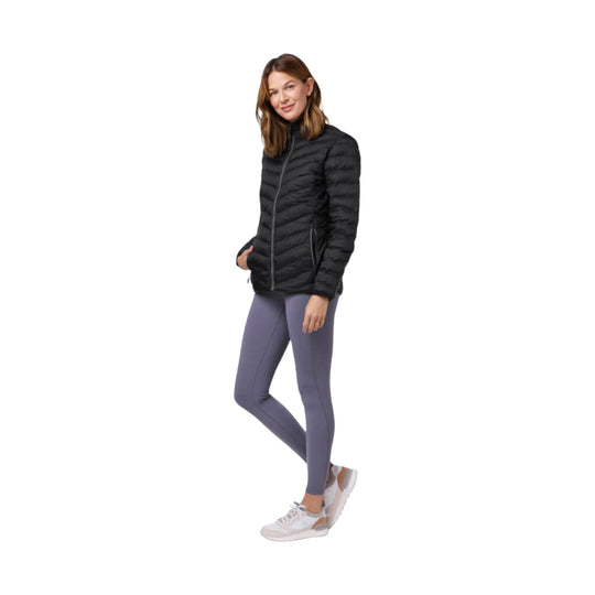 Black quilted zip-front puffer jacket with stand collar, shown with purple leggings and white sneakers