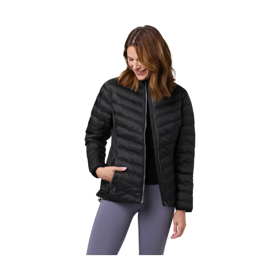 Black quilted zip-front puffer jacket with stand collar and side pockets, worn over leggings