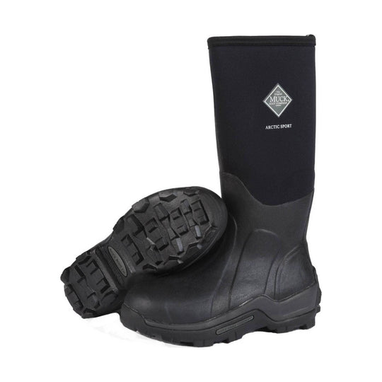 Black knee-high insulated rubber boot with lugged sole, shown with one boot standing and one lying on its side