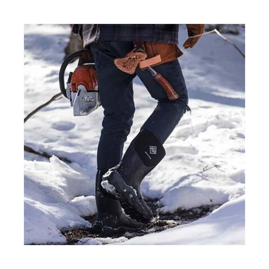 Black insulated knee-high rubber snow boots worn in snowy ground