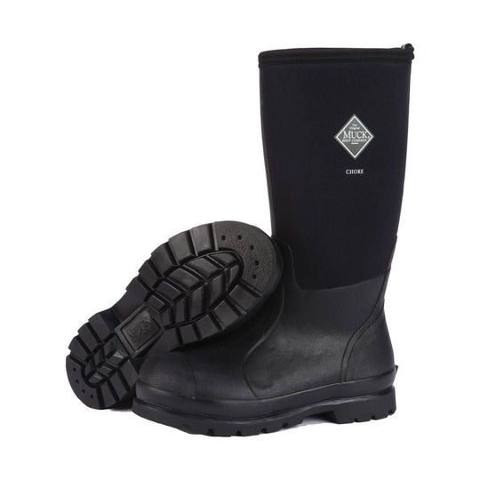 Black knee-high rubber work boot with thick lug sole, shown standing with one boot lying across it