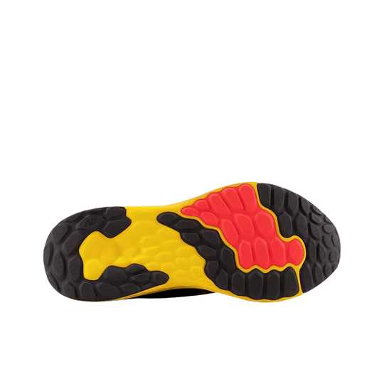 Black, yellow, and red athletic shoe outsole with rugged traction pattern