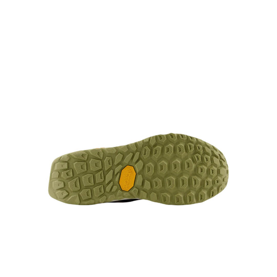 Olive trail shoe outsole with deep lug pattern and yellow logo insert
