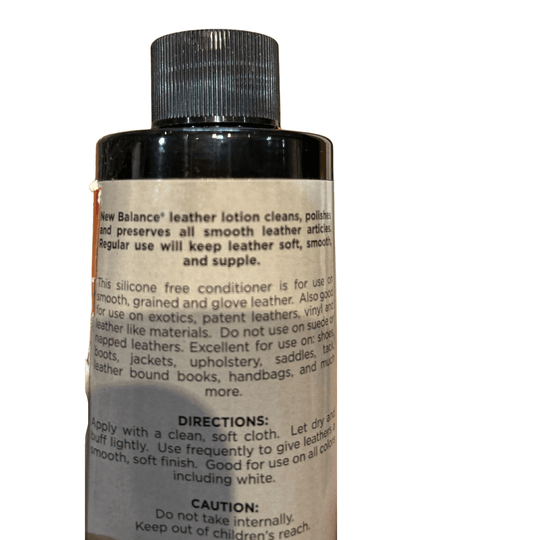 Black bottle of leather lotion with ribbed cap and beige label.