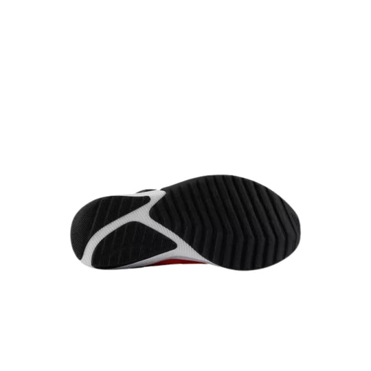 Black and white kids' athletic shoe sole with ribbed tread and a red accent