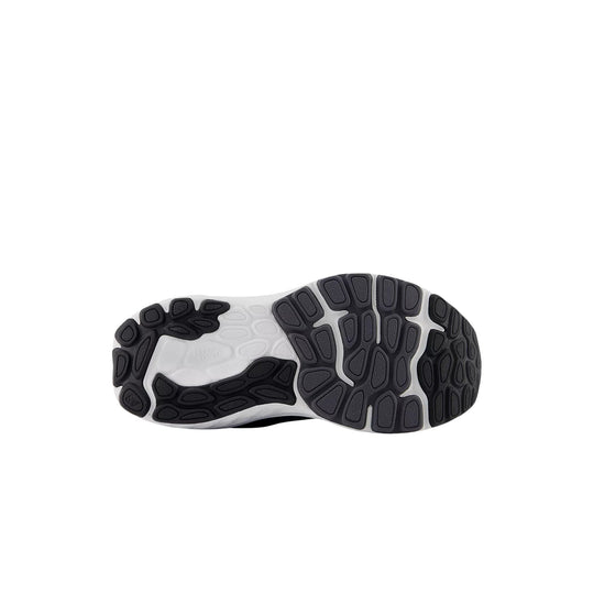 Shoe outsole with black rubber traction pods and a white midfoot section