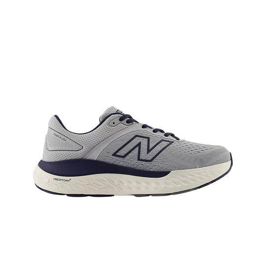 Gray running shoe with navy laces, large side logo, and thick white cushioned sole