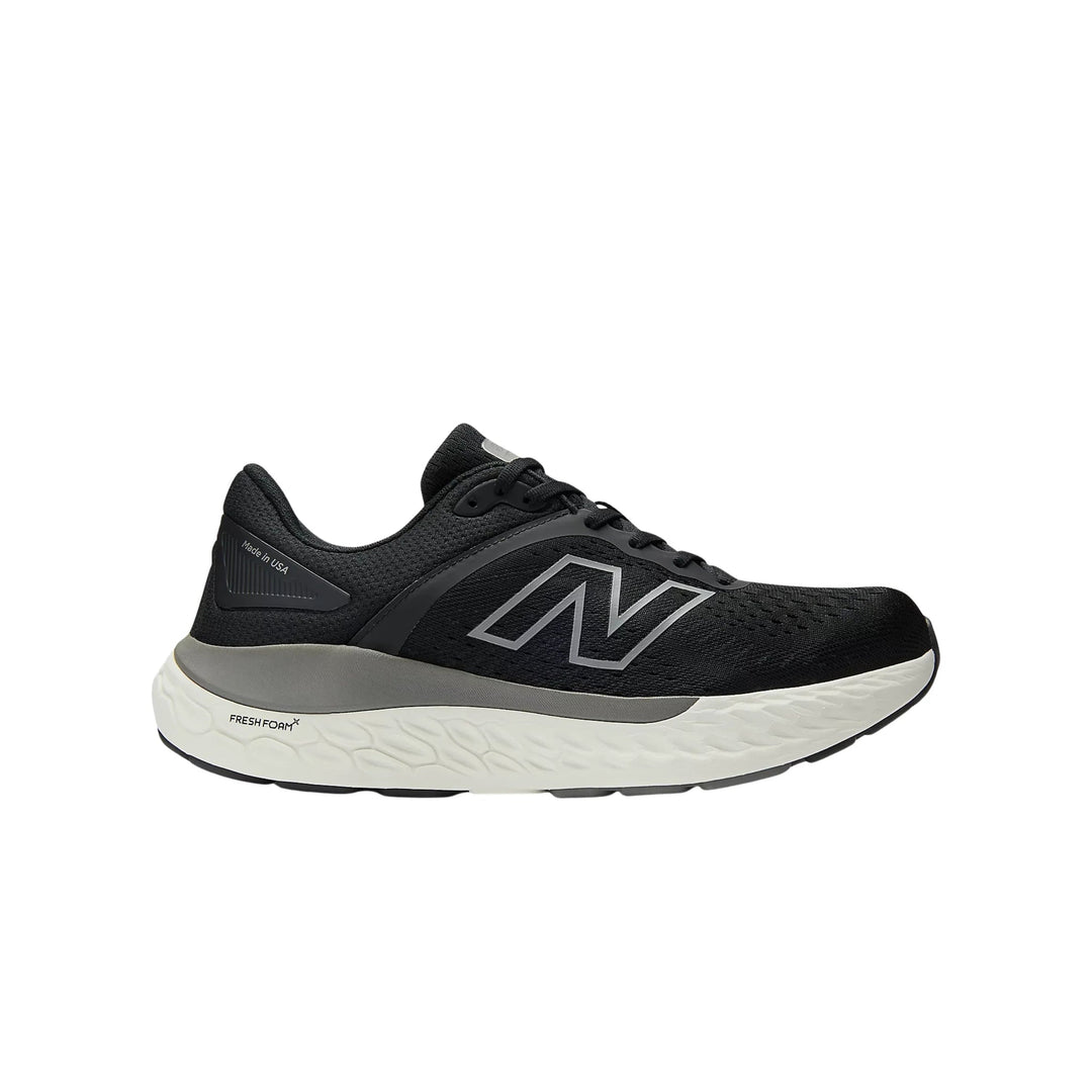 Black running shoe with a white cushioned sole and side logo, shown in profile