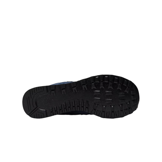 Black lugged shoe sole with speckled midsole edge and blue upper peeking above