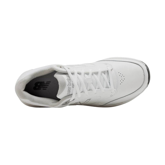 White low-top walking shoe with laces, perforated toe box, and padded collar, shown from above