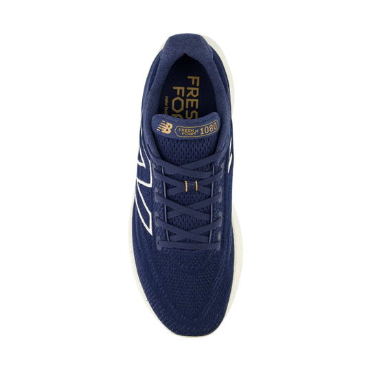 Navy running shoe with gold tongue label and white side logo, top view