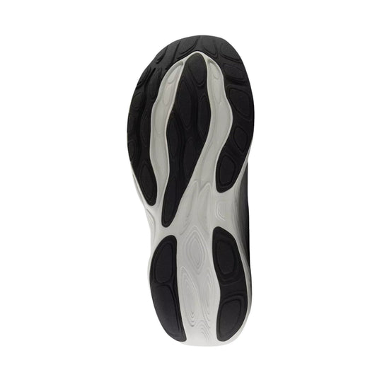 Black and white running shoe outsole with segmented tread pods