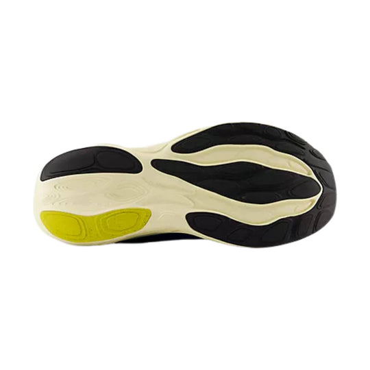 Running shoe outsole with cream midsole, black rubber tread, and a yellow forefoot patch