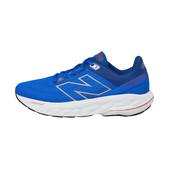Blue athletic running shoe with white cushioned sole and silver side logo, shown in side view
