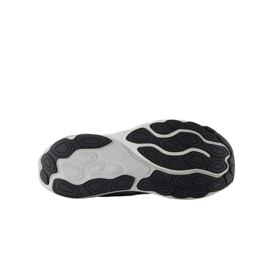 Black and white running shoe outsole with oval tread pods