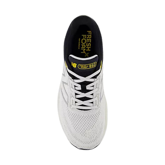 White running shoe with black tongue, white laces, and yellow tongue branding.