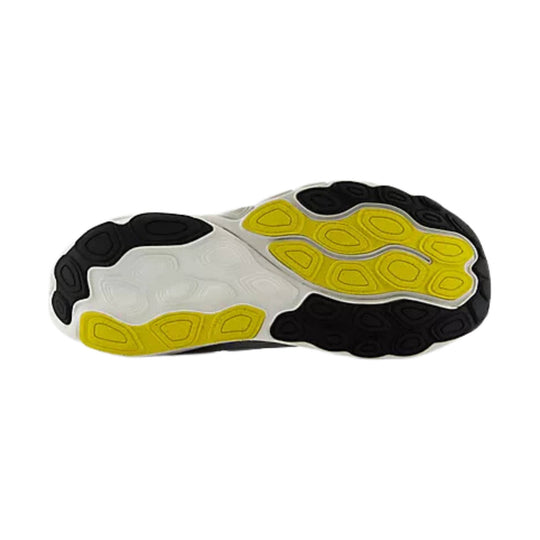 Shoe outsole with black tread and yellow and white cushioning pods