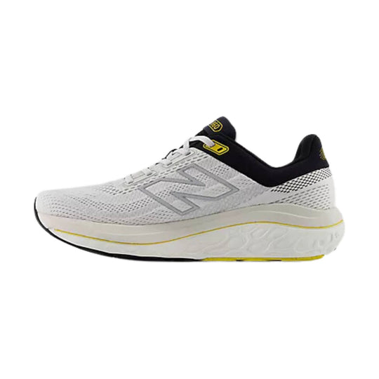 White running shoe with black collar, yellow accents, and a large side logo