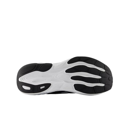 Black and white running shoe outsole with segmented traction pods