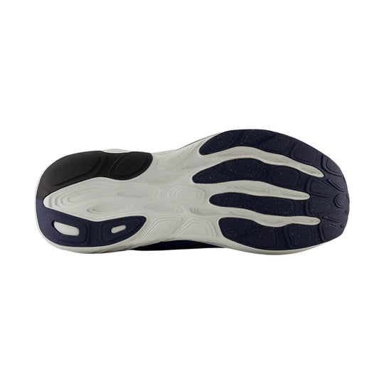 Running shoe outsole with white foam midsole and navy and black rubber traction pods