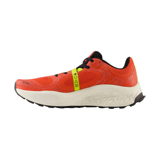 Orange trail running shoe with black laces, a lime strap, and a thick off-white sole