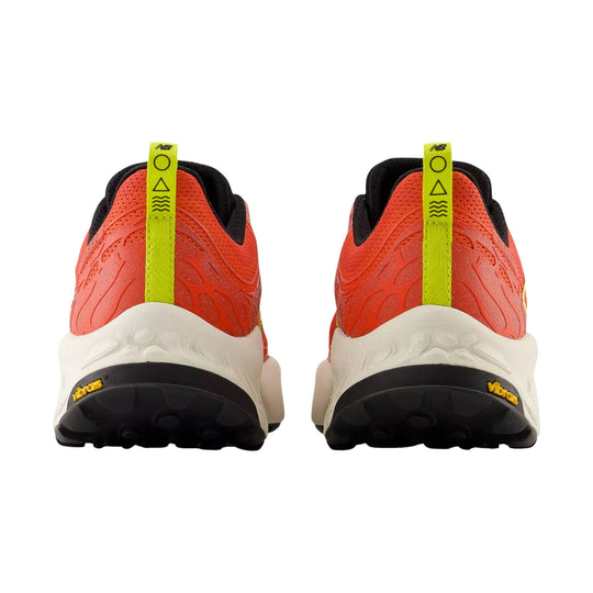 Pair of orange trail running shoes shown from the back with neon yellow heel tabs, black collars, and white midsoles