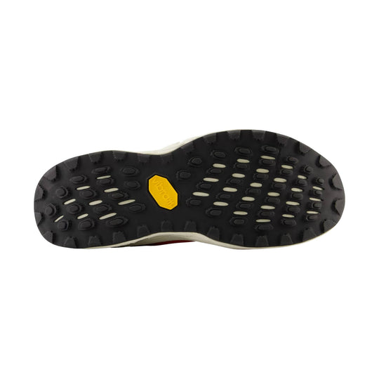 Black trail shoe outsole with a yellow Vibram badge