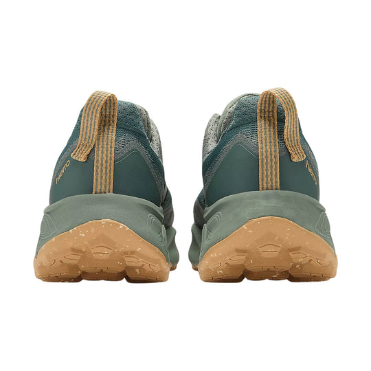 Pair of dark green trail running shoes with tan lugged soles, shown from the back with heel pulls.