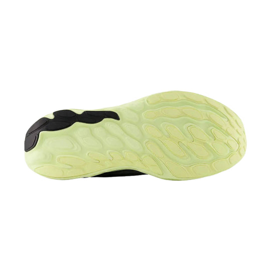 Pale yellow running shoe outsole with black rubber traction pods