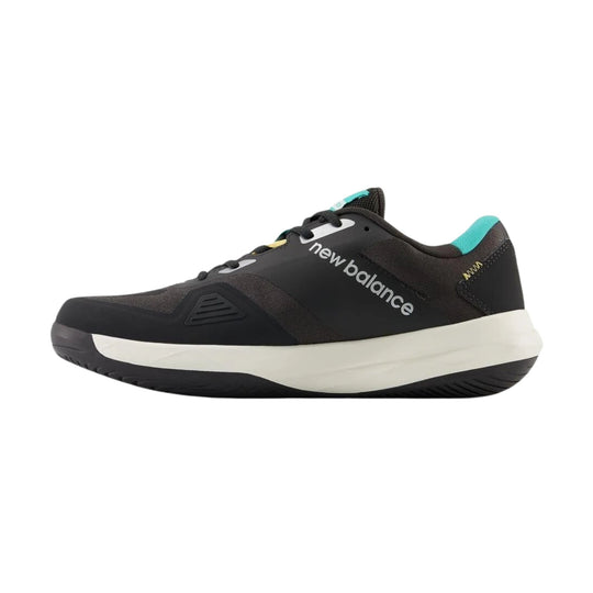 Black low-top tennis shoe with white midsole, teal heel collar, and visible New Balance logo