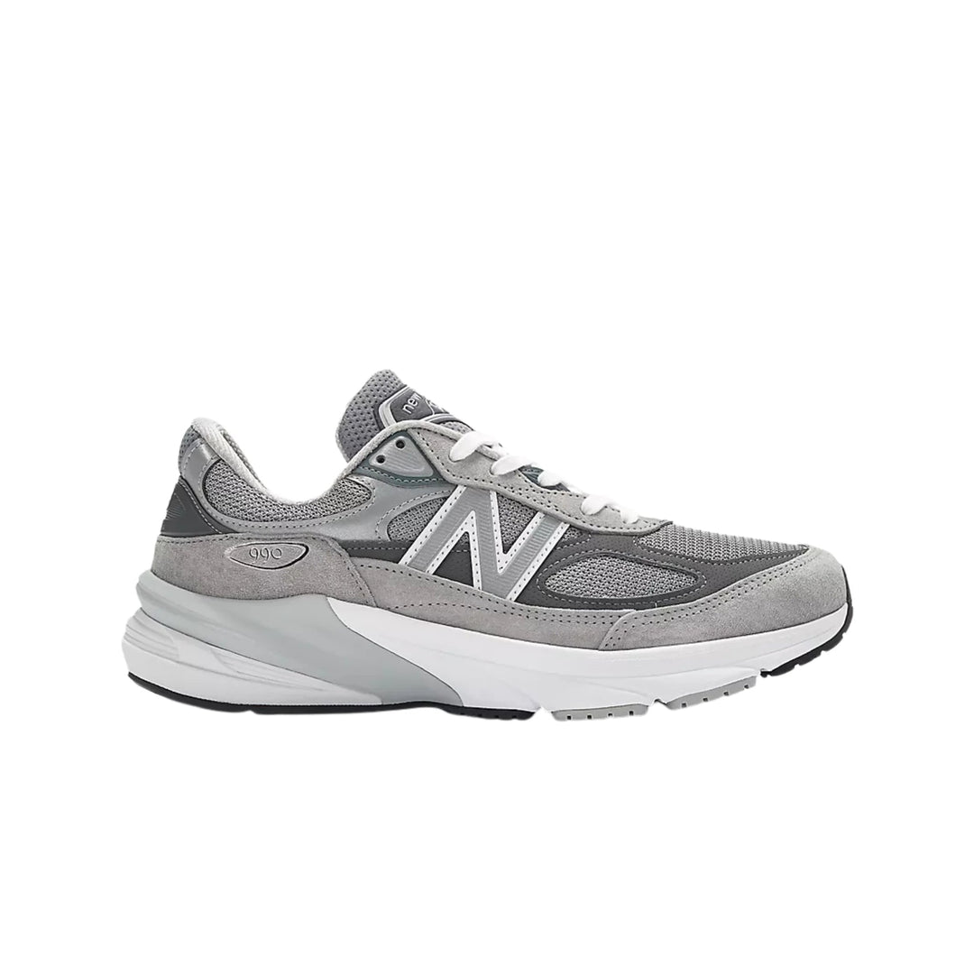 Grey and white athletic sneaker with mesh and suede panels, white laces, and a side logo.