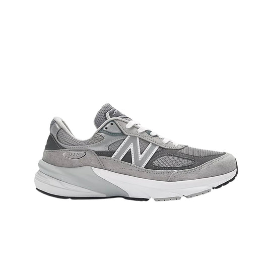 Grey and white athletic sneaker with mesh and suede panels, white laces, and a side logo.