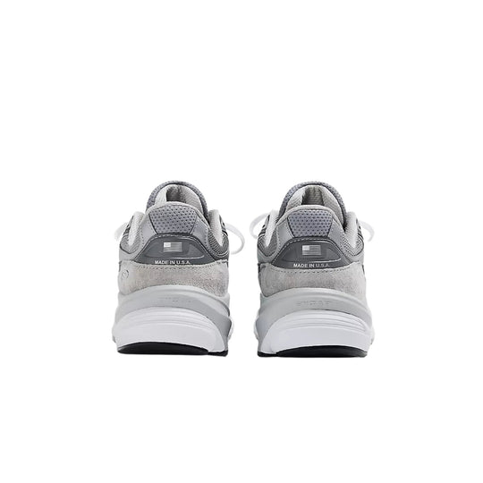 Grey athletic sneakers shown from the back with mesh uppers, white midsoles, and visible MADE IN U.S.A. text.
