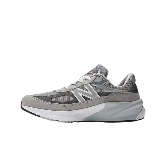 Gray New Balance sneaker in side view with mesh and suede panels, white laces, and a thick platform sole