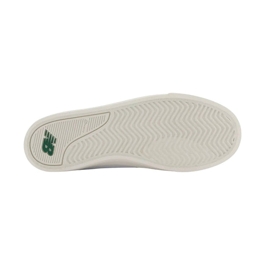 White sneaker outsole with wavy tread and a green logo at the heel