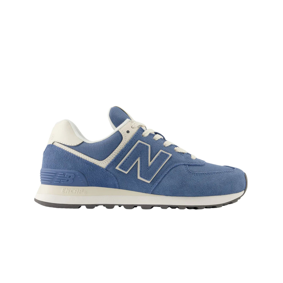 Blue suede New Balance sneaker with white trim and laces, shown in side profile