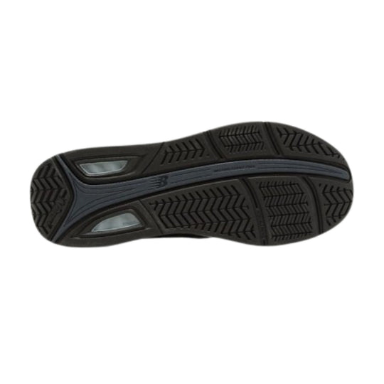 Black walking shoe outsole with deep tread and gray midfoot cushioning