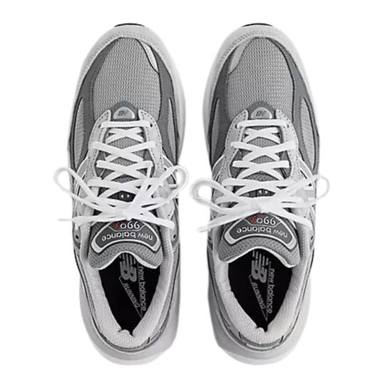 Pair of gray and white New Balance sneakers shown from above with white laces