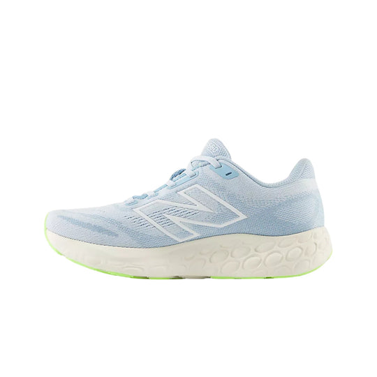 Light blue running shoe with a thick cream foam midsole and lime green outsole accents