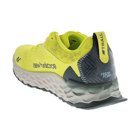 Yellow and gray trail running shoe with mesh upper, wavy foam sole, and heel pull tab