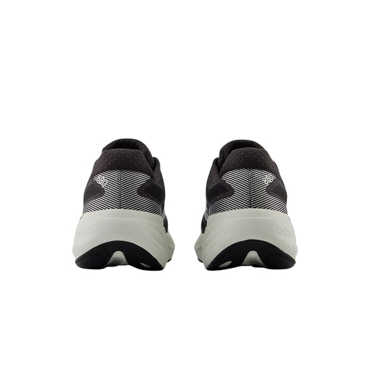 Black and white running shoes shown from the back with thick white midsoles