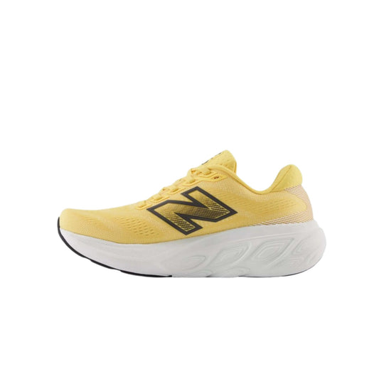 Yellow running shoe with a large black N logo and white foam sole