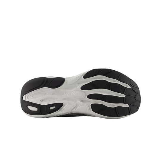 Running shoe outsole with black rubber pods and a white cushioned midsole