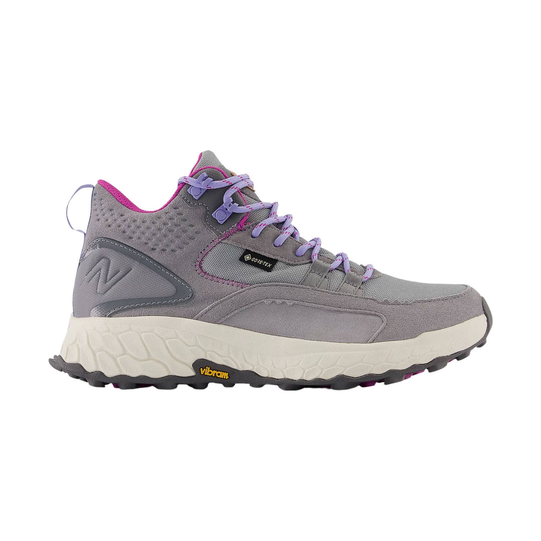 Gray mid-top hiking shoe with purple laces, magenta trim, and a chunky white Vibram sole