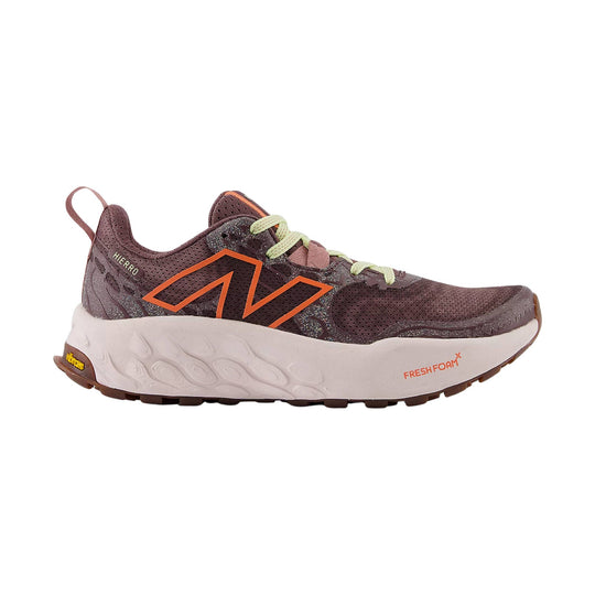Brown trail running shoe with orange side logo, light foam midsole, and lime laces