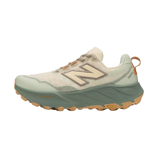 Light beige and sage trail running shoe with mesh upper, bungee laces, and rugged Vibram outsole