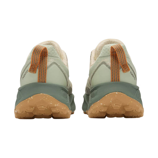 Back view of light green trail shoes with tan soles, orange pull tabs, and Hierro branding