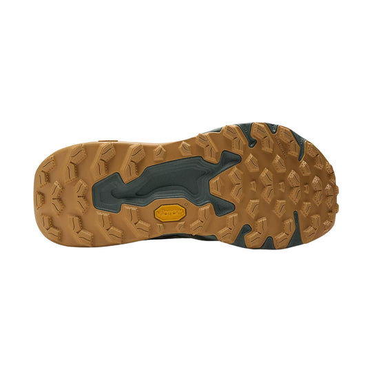 Trail shoe outsole with tan lugs, dark gray midfoot sections, and a Vibram logo