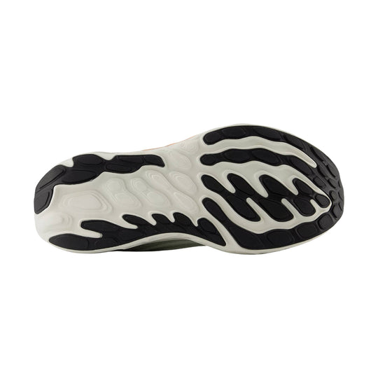 Black and white running shoe outsole with oval tread pods and segmented rubber traction pattern