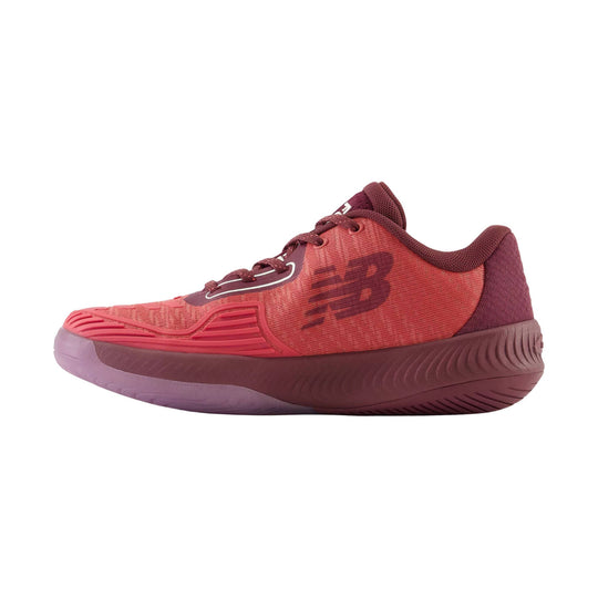 Brick red low-top tennis shoe with lace-up closure, textured upper, and thick cushioned sole